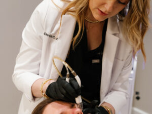 Aesthetic professional performing a C2 Glow Infusion TX on a male client at C2 Aesthetics